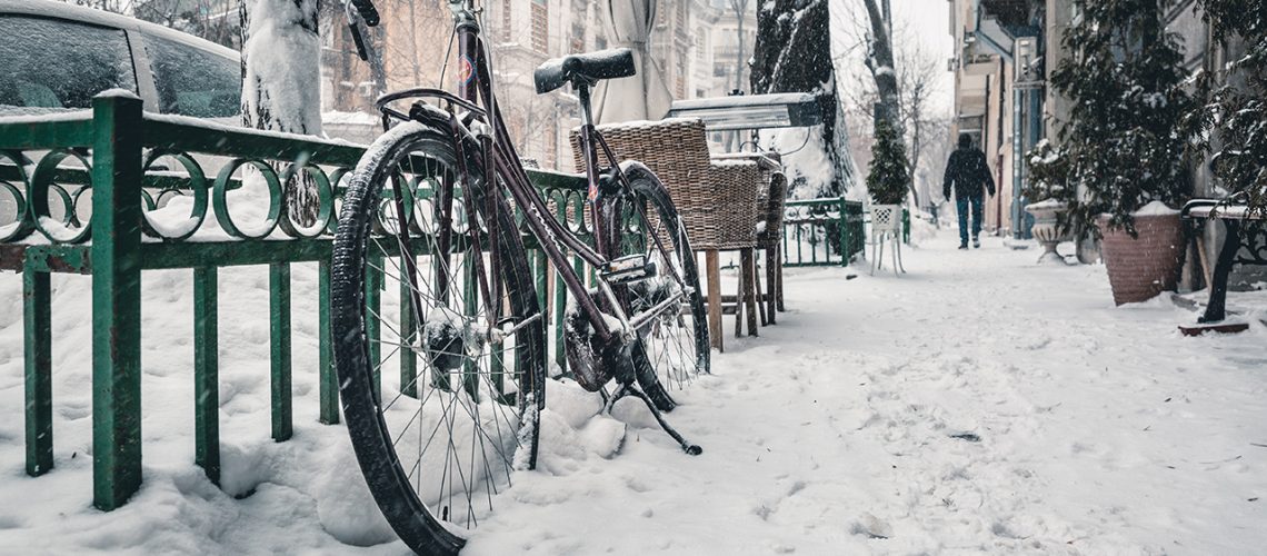 bicycle in snow, owner in need of upgrade to snow bike