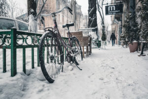 bicycle in snow, owner in need of upgrade to snow bike